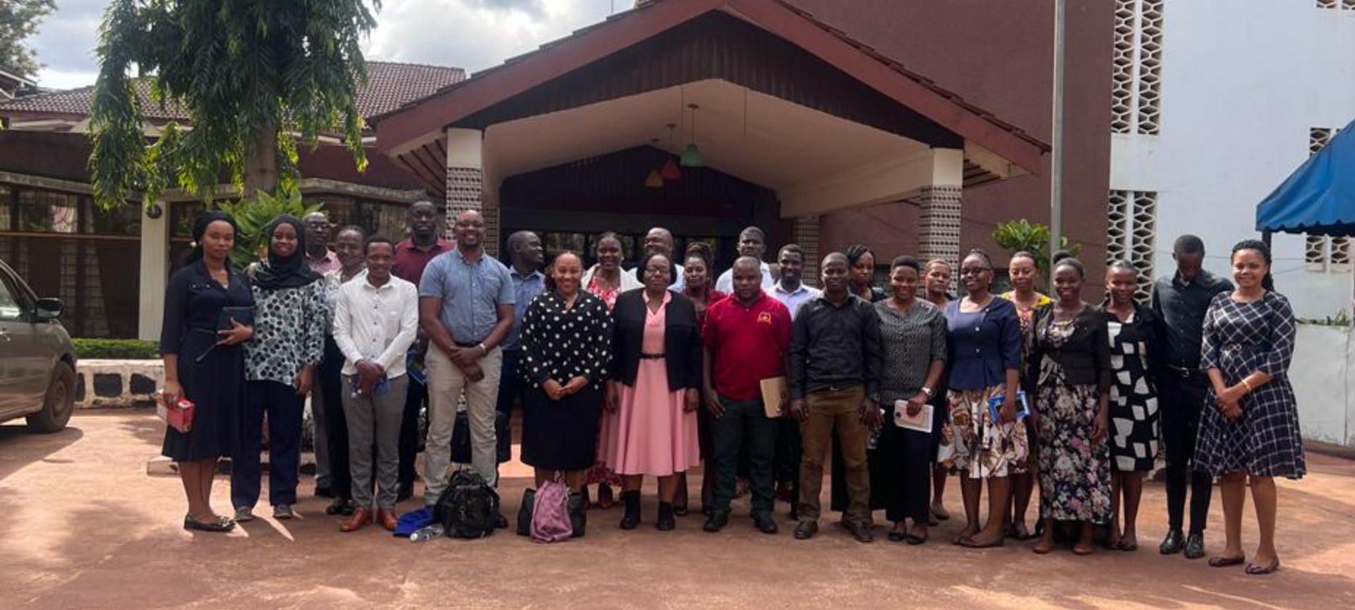 Dr. Eric Kioko and junior staff of Mzumbe University outside the Lumumba Complex after concluding a two-day workshop on international grants application.