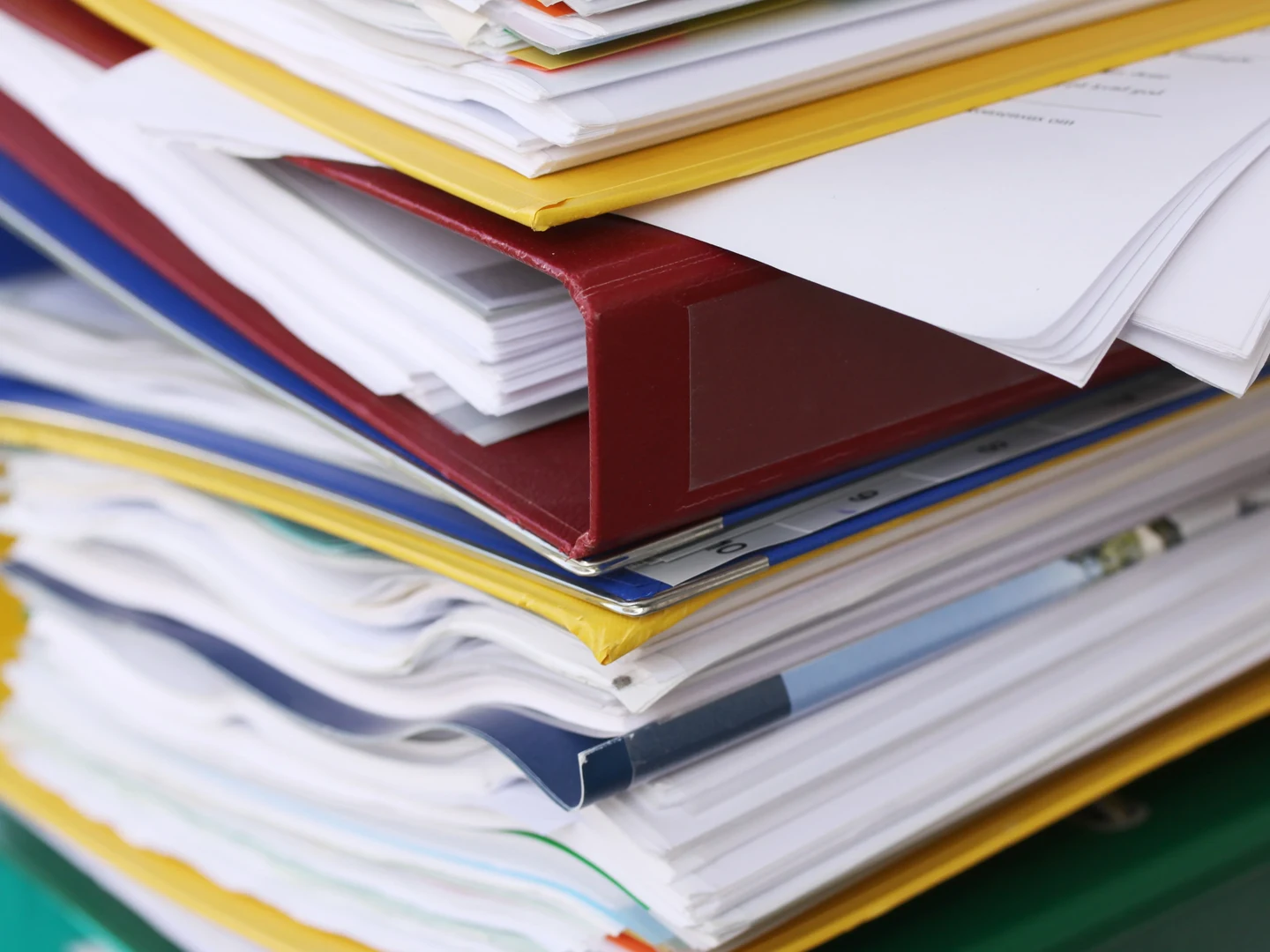 Eine Wissenschaftlerin und ein Wissenschaftler arbeiten hinter einer Glasfassade und mischen Chemikalien mit Großgeräten.